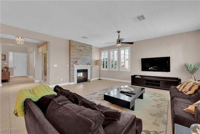 5542 Oak Bend Dr, Las Vegas, NV 89135 - living room with light tile patterned flooring, a large fireplace, and ceiling fan