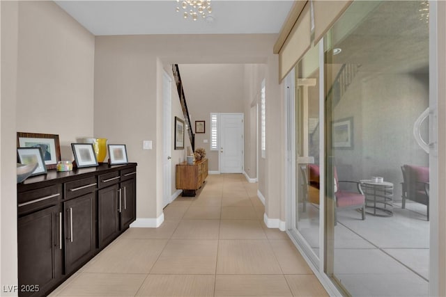 5542 Oak Bend Dr, Las Vegas, NV 89135 - hallway with light tile patterned floors and a chandelier