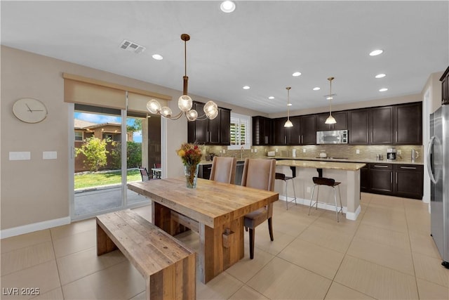 5542 Oak Bend Dr, Las Vegas, NV 89135 - dining area with light tile patterned floors and recessed lighting