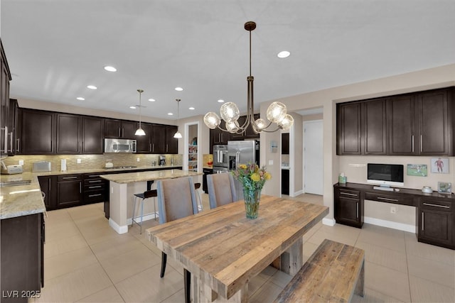 5542 Oak Bend Dr, Las Vegas, NV 89135 - dining space with light tile patterned floors, recessed lighting, and a chandelier