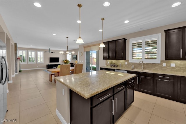 5542 Oak Bend Dr, Las Vegas, NV 89135 - kitchen with tasteful backsplash, open floor plan, light stone countertops, dark brown cabinets, and a kitchen island