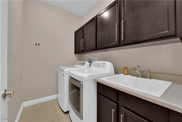5542 Oak Bend Dr, Las Vegas, NV 89135 - laundry area featuring cabinet space, independent washer and dryer, and light tile patterned floors
