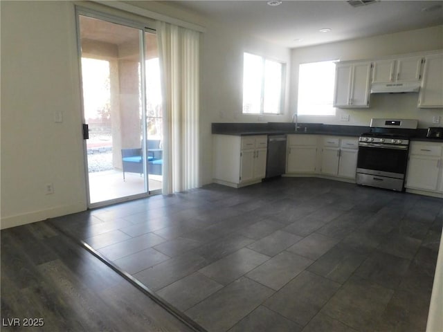 11173 Hickory Glen St, Las Vegas, NV 89179 - kitchen featuring stainless steel appliances, dark countertops, white cabinets, and under cabinet range hood