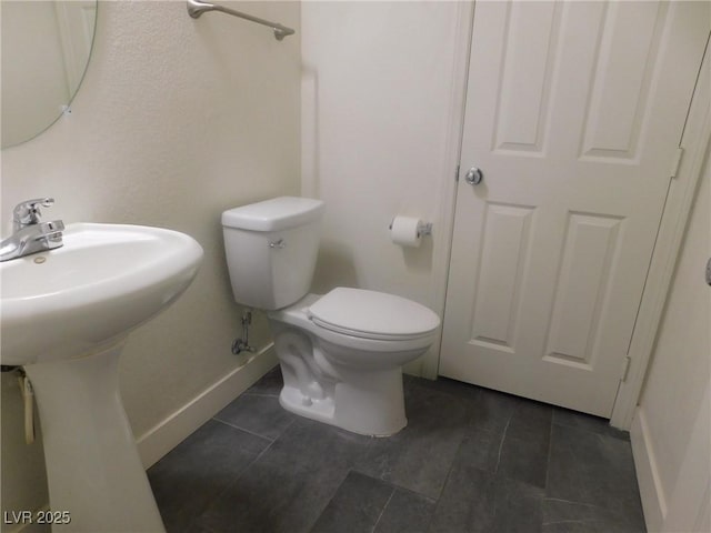 11173 Hickory Glen St, Las Vegas, NV 89179 - bathroom featuring baseboards, tile patterned flooring, and toilet