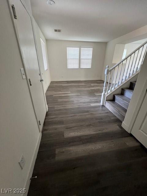 11173 Hickory Glen St, Las Vegas, NV 89179 - hallway with wood finished floors, stairway, and baseboards