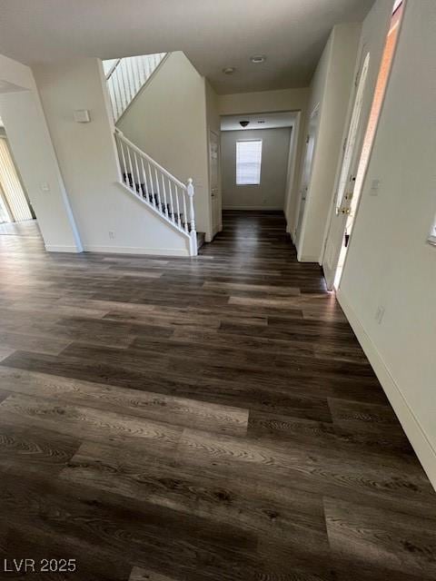 11173 Hickory Glen St, Las Vegas, NV 89179 - hall with dark wood finished floors, stairway, and baseboards
