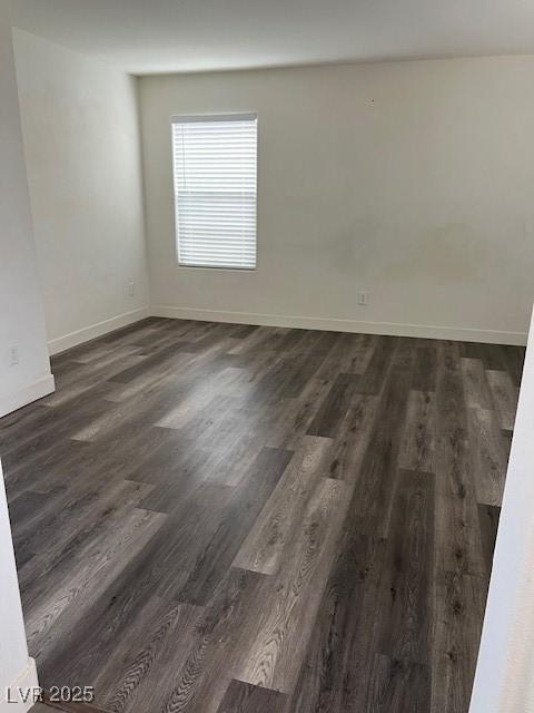11173 Hickory Glen St, Las Vegas, NV 89179 - spare room featuring dark wood-style floors and baseboards
