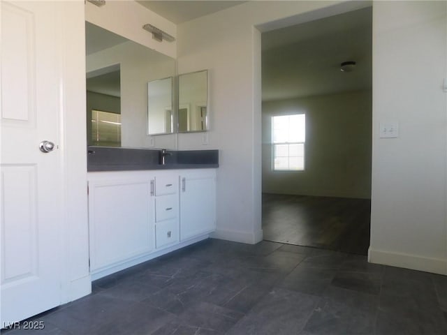 11173 Hickory Glen St, Las Vegas, NV 89179 - bathroom featuring double vanity and baseboards