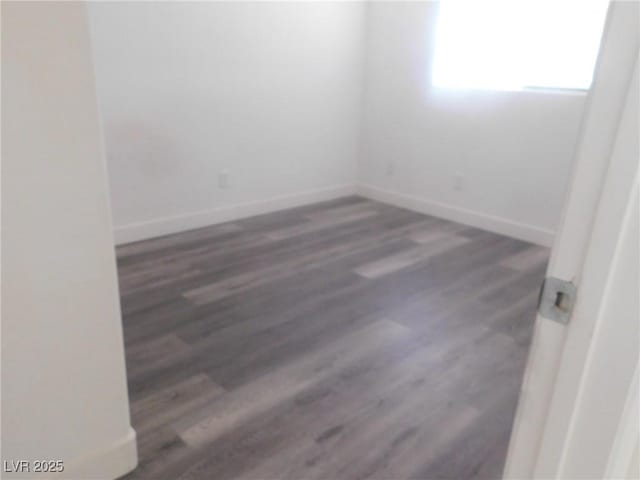 11173 Hickory Glen St, Las Vegas, NV 89179 - empty room featuring baseboards and wood finished floors