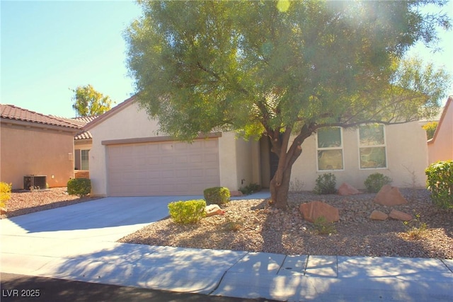 2212 Sawtooth Mountain Dr, Henderson, NV 89044 - view of front of home with concrete driveway, a garage, stucco siding, and cooling unit