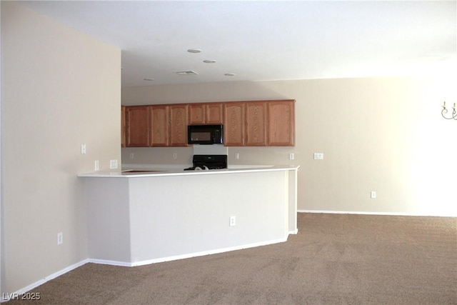 2212 Sawtooth Mountain Dr, Henderson, NV 89044 - kitchen featuring black microwave, range, carpet, light countertops, and a peninsula