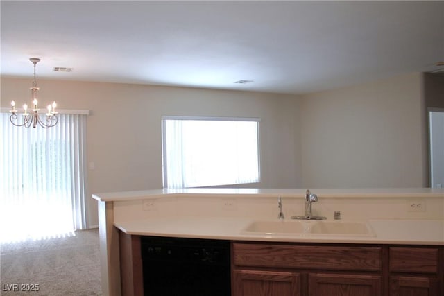 2212 Sawtooth Mountain Dr, Henderson, NV 89044 - kitchen with a sink, dishwasher, a chandelier, and light countertops