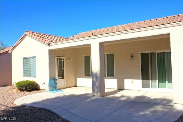 2212 Sawtooth Mountain Dr, Henderson, NV 89044 - back of house featuring a tiled roof, stucco siding, and a patio