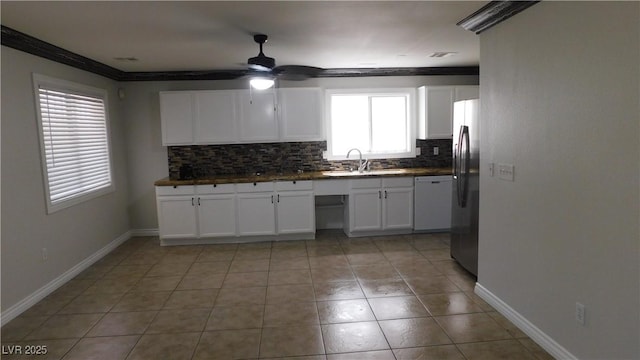 3606 Gold Sluice Ave, North Las Vegas, NV 89032 - kitchen featuring dishwasher, a sink, freestanding refrigerator, backsplash, and white cabinetry