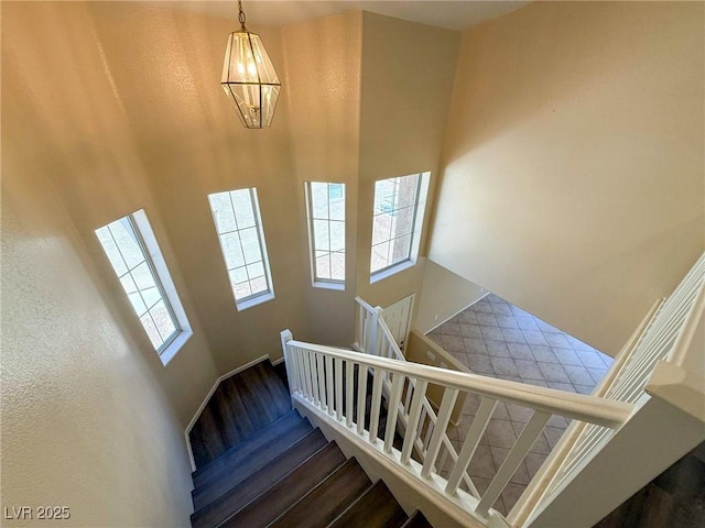 3736 Gallowtree Ave, North Las Vegas, NV 89081 - staircase with a towering ceiling, wood finished floors, and a chandelier