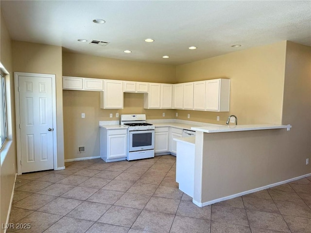 3736 Gallowtree Ave, North Las Vegas, NV 89081 - kitchen with white appliances, a peninsula, recessed lighting, white cabinetry, and light tile patterned floors