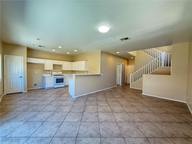 3736 Gallowtree Ave, North Las Vegas, NV 89081 - kitchen with white stove, open floor plan, white cabinetry, light tile patterned floors, and recessed lighting