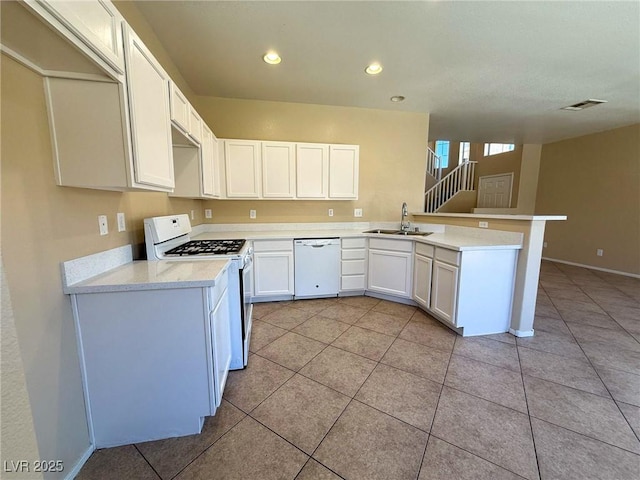 3736 Gallowtree Ave, North Las Vegas, NV 89081 - kitchen featuring white appliances, a peninsula, light countertops, light tile patterned flooring, and recessed lighting