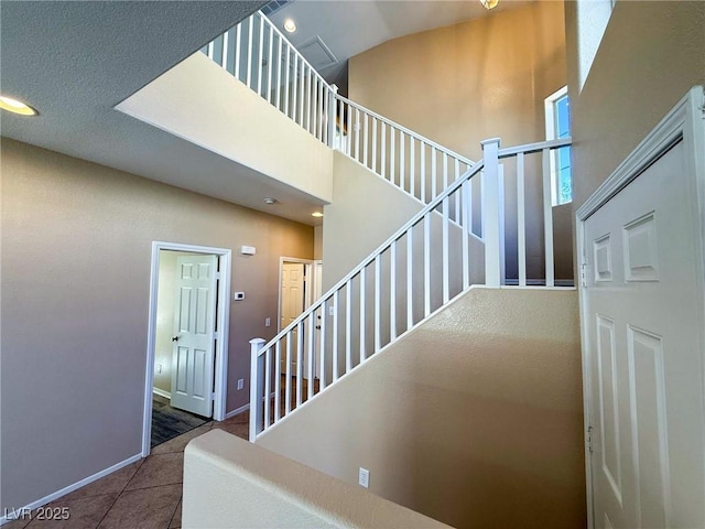 3736 Gallowtree Ave, North Las Vegas, NV 89081 - stairway featuring tile patterned flooring, a towering ceiling, and recessed lighting