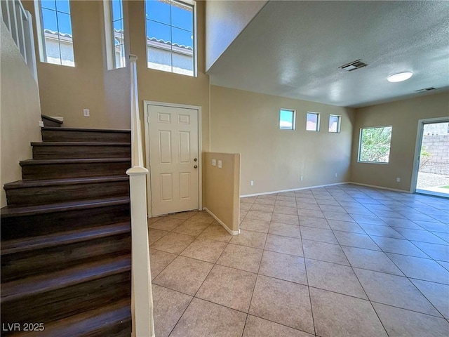 3736 Gallowtree Ave, North Las Vegas, NV 89081 - foyer with light tile patterned flooring, stairs, and a textured ceiling
