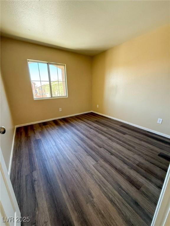 3736 Gallowtree Ave, North Las Vegas, NV 89081 - spare room featuring dark wood-style flooring and baseboards