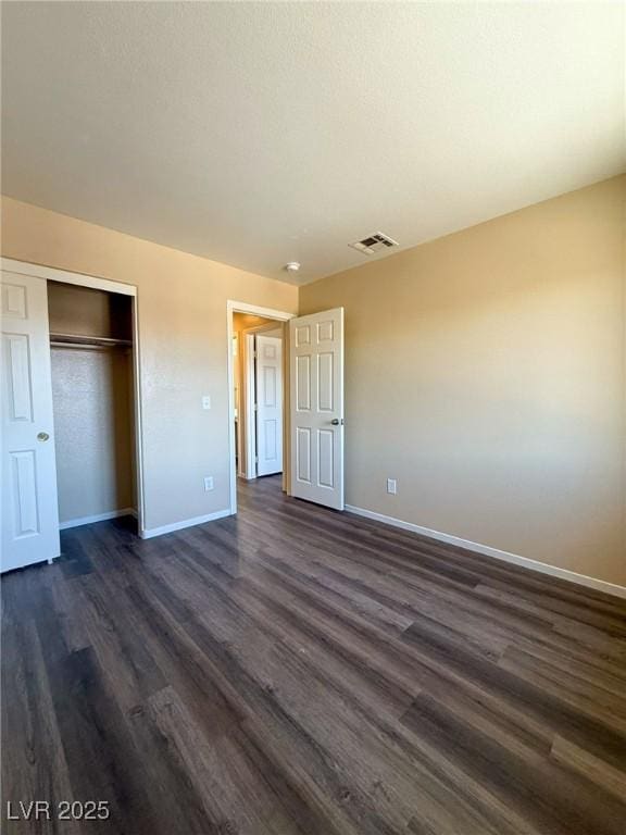 3736 Gallowtree Ave, North Las Vegas, NV 89081 - unfurnished bedroom with dark wood-style flooring and a closet