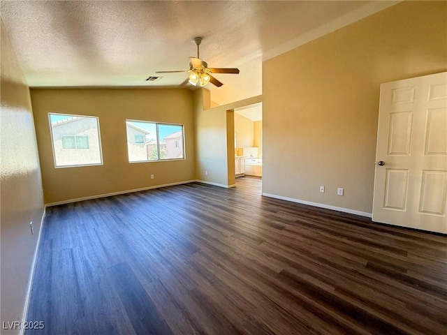 3736 Gallowtree Ave, North Las Vegas, NV 89081 - spare room with vaulted ceiling, a ceiling fan, dark wood-style flooring, and a textured ceiling