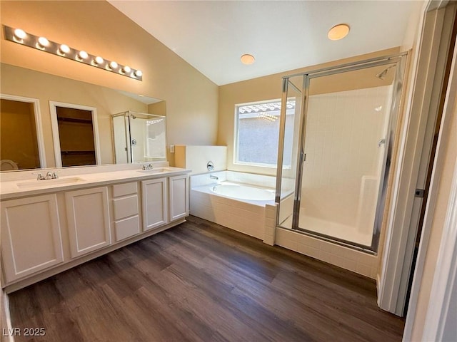 3736 Gallowtree Ave, North Las Vegas, NV 89081 - bathroom featuring vaulted ceiling, a shower stall, a bath, double vanity, and wood finished floors