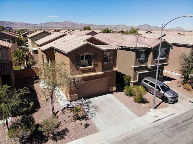 3736 Gallowtree Ave, North Las Vegas, NV 89081 - view of front facade featuring stucco siding, an attached garage, a tile roof, a mountain view, and concrete driveway