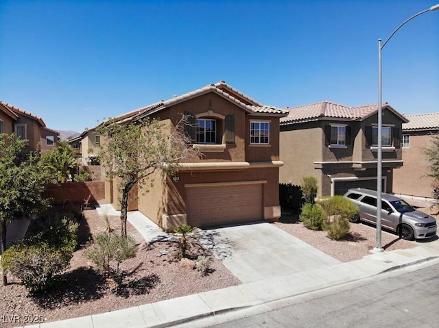 3736 Gallowtree Ave, North Las Vegas, NV 89081 - view of front of home featuring a garage, stucco siding, a tiled roof, and concrete driveway