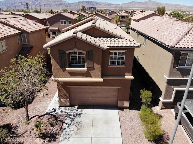 3736 Gallowtree Ave, North Las Vegas, NV 89081 - mediterranean / spanish-style home featuring an attached garage, a mountain view, stucco siding, and a residential view