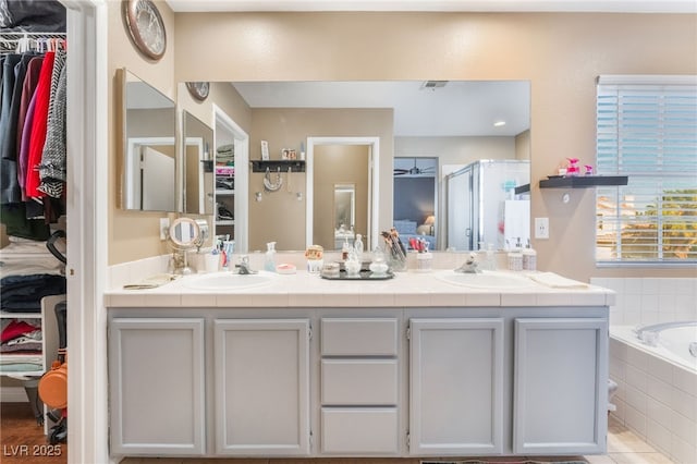 2789 Trotwood Ln, Las Vegas, NV 89108 - bathroom featuring a spacious closet, double vanity, a shower stall, and a bath