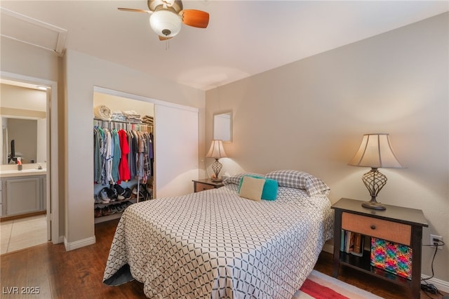 2789 Trotwood Ln, Las Vegas, NV 89108 - bedroom with wood finished floors, a closet, baseboards, ceiling fan, and a walk in closet