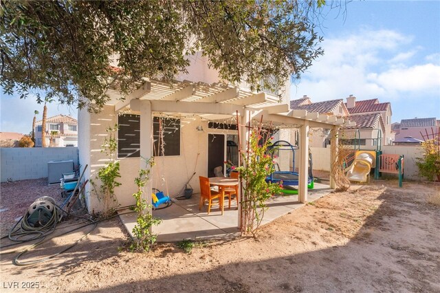 2789 Trotwood Ln, Las Vegas, NV 89108 - back of property featuring stucco siding, a pergola, a patio, a tile roof, and a playground
