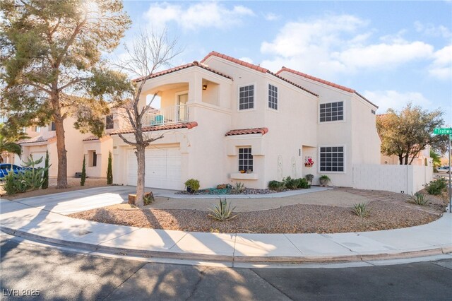 2789 Trotwood Ln, Las Vegas, NV 89108 - mediterranean / spanish-style home with a balcony, a tile roof, driveway, stucco siding, and an attached garage