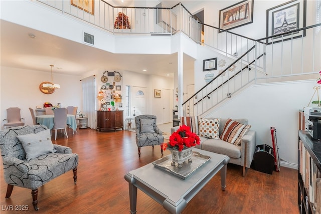 2789 Trotwood Ln, Las Vegas, NV 89108 - living room with stairway, a high ceiling, wood finished floors, and a chandelier