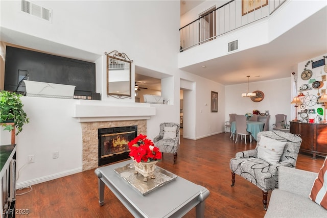 2789 Trotwood Ln, Las Vegas, NV 89108 - living room featuring a fireplace, wood finished floors, baseboards, and a towering ceiling