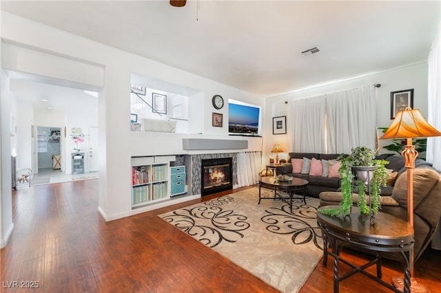 2789 Trotwood Ln, Las Vegas, NV 89108 - living room featuring a fireplace, wood finished floors, and baseboards