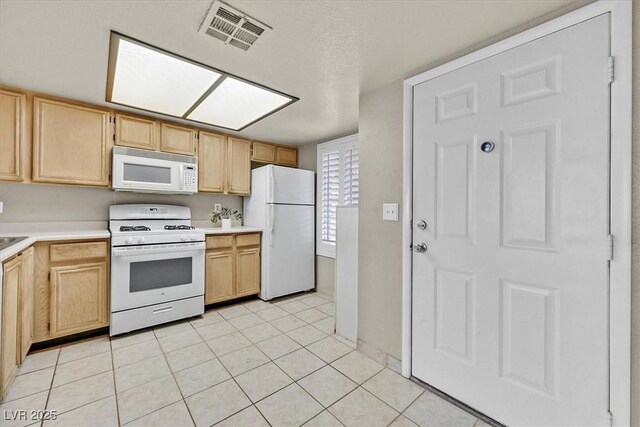 8070 W Russell Rd Unit 1036, Las Vegas, NV 89113 - kitchen with white appliances, light brown cabinets, and light countertops