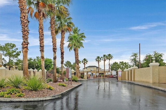 8070 W Russell Rd Unit 1036, Las Vegas, NV 89113 - view of asphalt road featuring a gate, curbs, and a gated entry