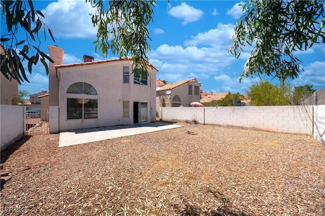 1436 Padre Bay Dr, Las Vegas, NV 89108 - rear view of house with a chimney, stucco siding, a fenced backyard, and a patio