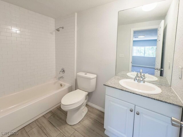 2713 Valley St, Las Vegas, NV 89101 - bathroom featuring vanity, toilet, wood finished floors, bathing tub / shower combination, and baseboards