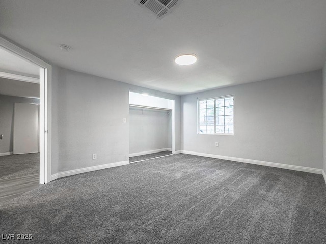 2713 Valley St, Las Vegas, NV 89101 - unfurnished bedroom featuring dark colored carpet, baseboards, and a closet