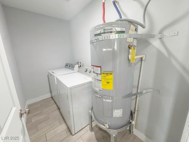 2713 Valley St, Las Vegas, NV 89101 - laundry room with washer and clothes dryer, water heater, light wood-type flooring, and baseboards