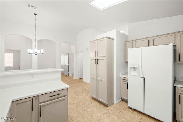 5112 Foggia Ave, Las Vegas, NV 89130 - kitchen with white refrigerator with ice dispenser, a chandelier, light countertops, and light tile patterned floors