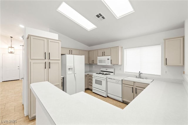 5112 Foggia Ave, Las Vegas, NV 89130 - kitchen with white appliances, lofted ceiling, a sink, light tile patterned floors, and light countertops