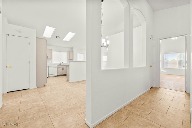 5112 Foggia Ave, Las Vegas, NV 89130 - hall with light tile patterned floors, a skylight, a sink, arched walkways, and a chandelier
