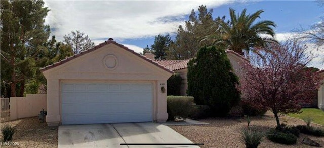 4410 La Reina Cir, Las Vegas, NV 89130 - view of front of home with stucco siding, driveway, and a tile roof