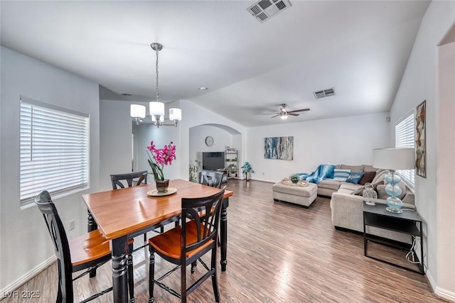 8567 Little Fox St, Las Vegas, NV 89123 - dining area with vaulted ceiling, wood finished floors, baseboards, a ceiling fan, and a chandelier