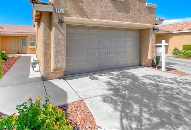 8567 Little Fox St, Las Vegas, NV 89123 - garage featuring concrete driveway